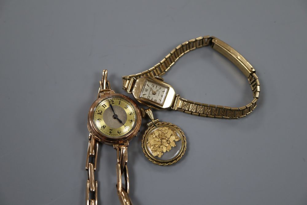 A 9ct gold-cased ladys wristwatch, another ladys wristwatch and a glazed pendant containing gold flakes